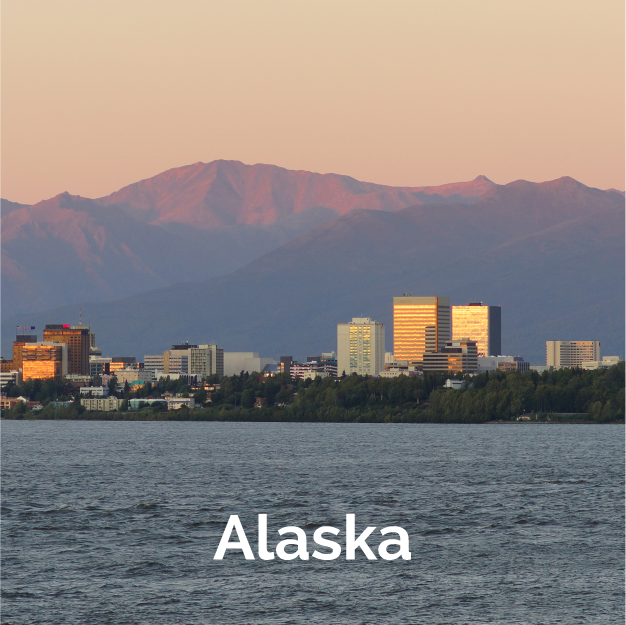 Alaska skyline view from the ocean with mountains in the background.