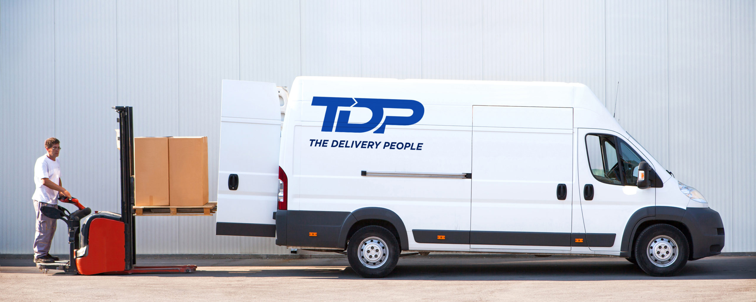 TDP Courier Is Loading The Van With Parcels