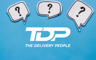 The Delivery People logo in white font with question marks above logo with blue background